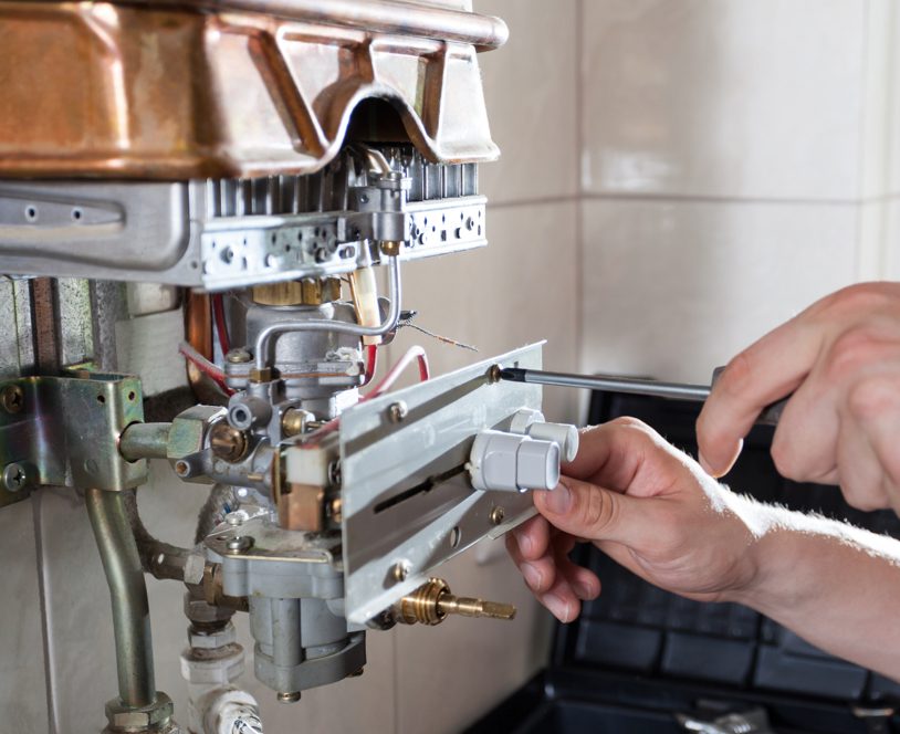 An plumber installing a new boiler in a house in Southampton.